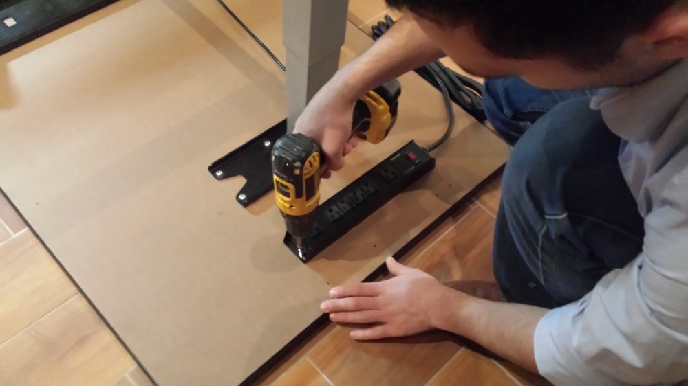 Install surge protector power strip under desk