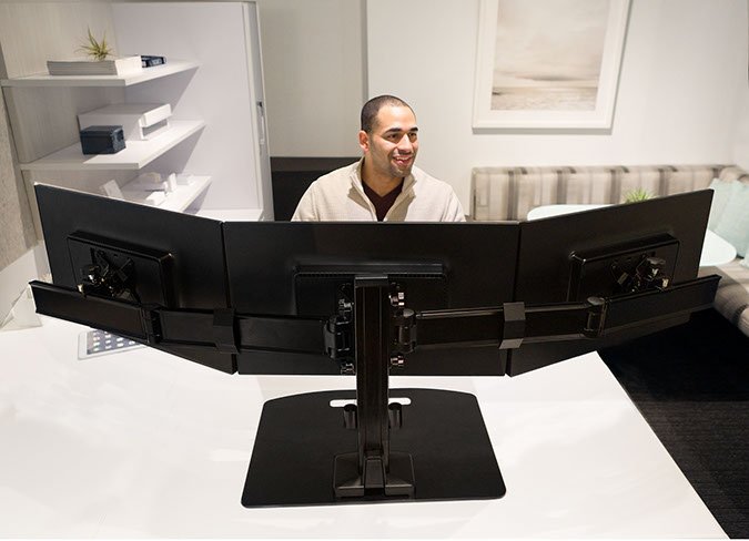 Ergotech Triple Monitor Horizontal Desk Stand in application