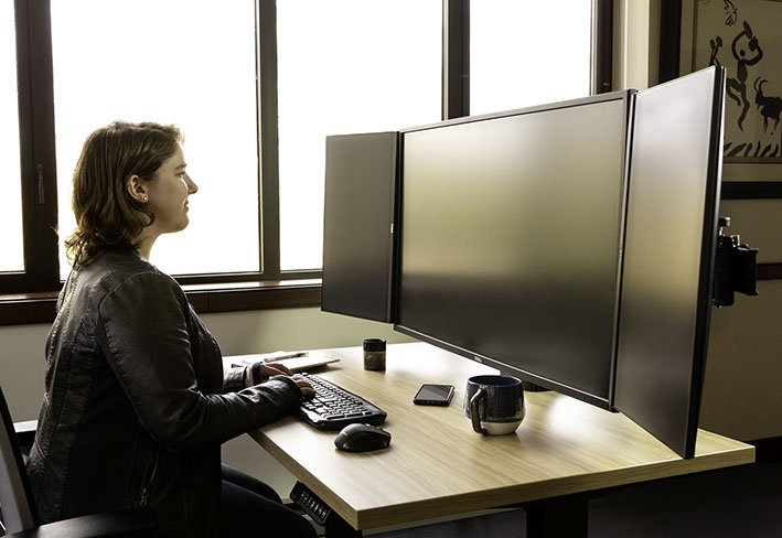 Ergotech Triple Monitor Horizontal Desk Stand in application