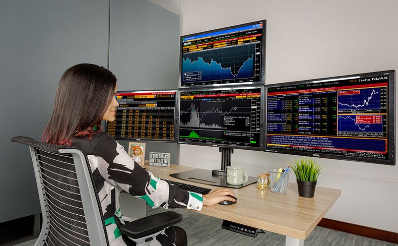 Ergotech Quad 1x3 Monitor Desk Stand in application